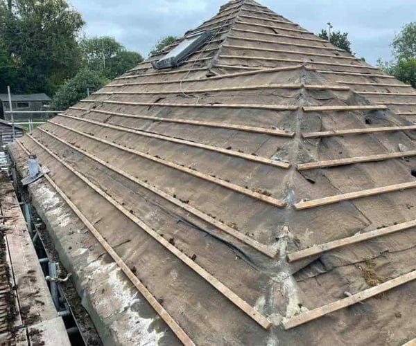 This is a photo of a hip roof that has been stripped back to the battens, and is awaiting a new roof covering to be installed. Works carried out by JYT Roofing Hitchin